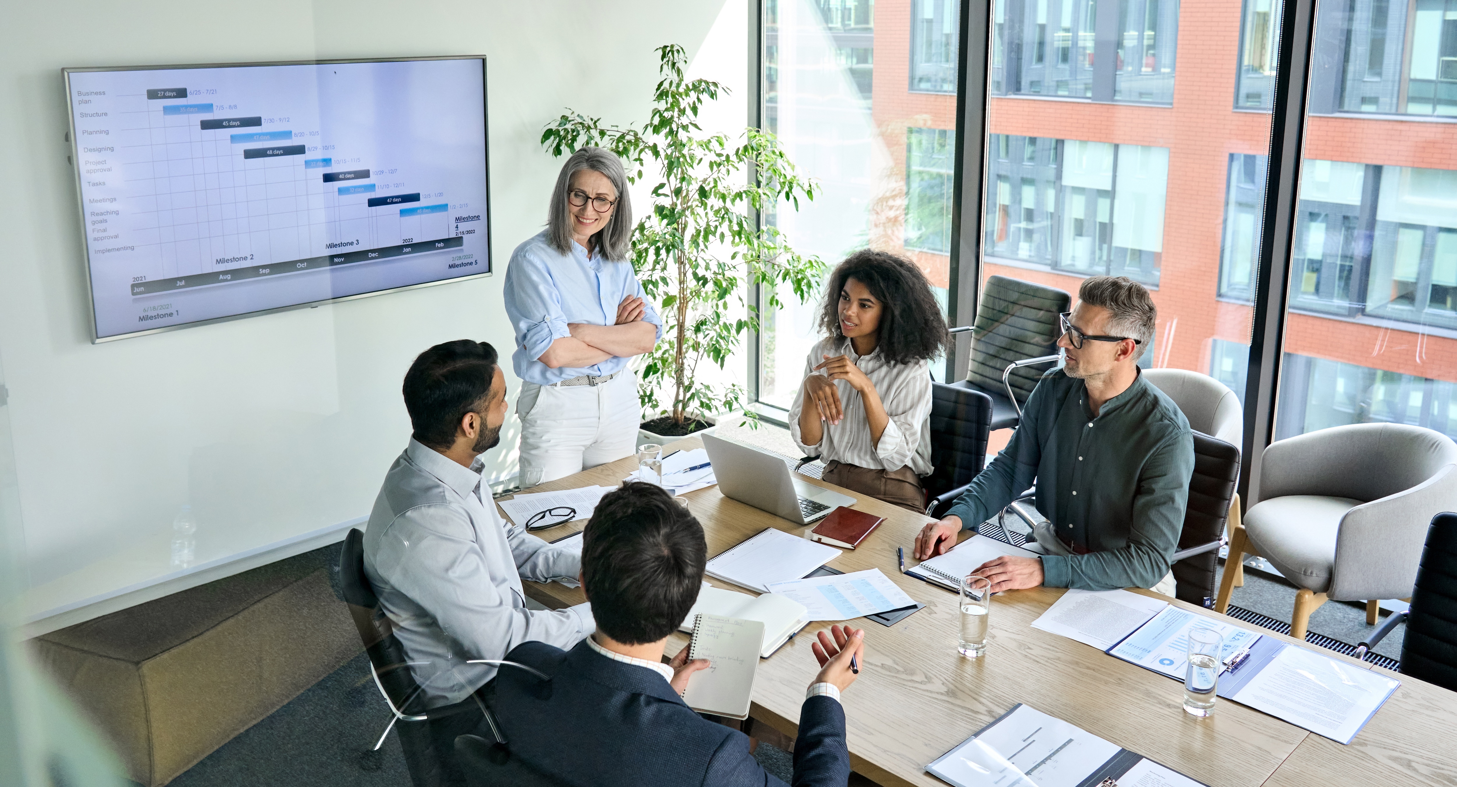 team in a board meeting reviewing something